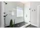 Modern shower with glass enclosure, black fixtures, and tiled walls at 4662 S Calico Rd, Gilbert, AZ 85297