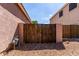 Side yard featuring a wooden gate, providing privacy and access to the property at 4662 S Calico Rd, Gilbert, AZ 85297