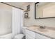Bathroom showcasing vanity, bathtub, and shower with curtain at 5302 E Van Buren St # 2024, Phoenix, AZ 85008