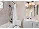 Well-lit bathroom with tiled shower, modern vanity, and sleek fixtures at 5302 E Van Buren St # 2024, Phoenix, AZ 85008