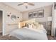 Bright bedroom with neutral tones, ceiling fan, and decorative wall art at 5302 E Van Buren St # 2024, Phoenix, AZ 85008