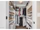 Walk-in closet featuring built-in shelving, racks, and ample storage space at 5302 E Van Buren St # 2024, Phoenix, AZ 85008