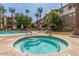 Relaxing hot tub with pristine blue tile and refreshing clear water in a tropical setting at 5302 E Van Buren St # 2024, Phoenix, AZ 85008