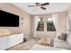 Cozy living room with neutral tones, large windows, and comfortable furnishings at 5302 E Van Buren St # 2024, Phoenix, AZ 85008