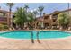 A pristine pool, surrounded by lush landscaping, offers a relaxing community space at 5302 E Van Buren St # 2024, Phoenix, AZ 85008