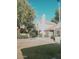 Exterior of the home featuring a red tiled roof, well maintained lawn, and desert landscaping at 5704 E Aire Libre Ave # 1038, Scottsdale, AZ 85254