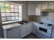 Bright kitchen featuring white cabinets and modern appliances at 5704 E Aire Libre Ave # 1038, Scottsdale, AZ 85254