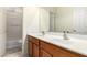 Bathroom with double sinks, wood cabinets and a shower-tub combo at 6118 S 46Th Ave, Laveen, AZ 85339