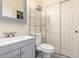 Cozy bathroom featuring a clean white toilet, a mirrored vanity and a metal storage shelf at 6118 S 46Th Ave, Laveen, AZ 85339