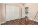 Bedroom with hardwood floors, a closet, and an open doorway at 6118 S 46Th Ave, Laveen, AZ 85339