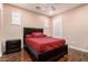 Comfortable bedroom featuring a dark wood bed, matching nightstand and hardwood floors at 6118 S 46Th Ave, Laveen, AZ 85339