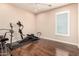 Light-filled exercise room with wood flooring and plenty of space for your home fitness routine at 6118 S 46Th Ave, Laveen, AZ 85339