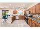 Well-lit kitchen with tile backsplash, stainless steel appliances, and an island with barstool seating at 6118 S 46Th Ave, Laveen, AZ 85339