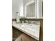 Elegant bathroom featuring a marble countertop, modern faucet, and illuminated mirror at 6525 E Cave Creek Rd # 101, Cave Creek, AZ 85331