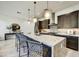Spacious kitchen featuring a large marble island, pendant lighting, and stainless steel appliances at 6525 E Cave Creek Rd # 101, Cave Creek, AZ 85331