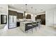 Modern kitchen with marble island, stainless steel refrigerator, and pendant lighting at 6525 E Cave Creek Rd # 101, Cave Creek, AZ 85331