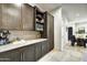 Convenient kitchenette area with sleek cabinets, marble countertops, and a modern microwave at 6525 E Cave Creek Rd # 101, Cave Creek, AZ 85331