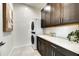 Well-organized laundry room featuring a stackable washer/dryer, modern cabinetry, and ample countertop space at 6525 E Cave Creek Rd # 101, Cave Creek, AZ 85331