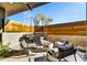 Outdoor patio showcasing a built-in grill, comfortable seating, and a cozy fire pit perfect for entertaining at 6525 E Cave Creek Rd # 101, Cave Creek, AZ 85331
