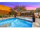 Inviting pool and spa area with lounge chairs, dining table, and lush landscaping against a beautiful sunset backdrop at 6525 E Cave Creek Rd # 101, Cave Creek, AZ 85331