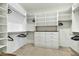 Spacious walk-in closet with custom white shelving, drawers, and ample storage space for clothing and accessories at 6525 E Cave Creek Rd # 101, Cave Creek, AZ 85331