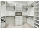 Walk-in closet featuring custom white shelving, drawers, and ample storage space at 6525 E Cave Creek Rd # 101, Cave Creek, AZ 85331