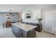Modern kitchen features a large island, white cabinets, and stainless steel appliances at 696 W Mesquite St, Chandler, AZ 85225