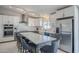 Modern kitchen with gray and white cabinets, an island with seating, and stainless steel appliances at 696 W Mesquite St, Chandler, AZ 85225