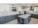 Modern kitchen with gray and white cabinets, an island with seating, and stainless steel appliances at 696 W Mesquite St, Chandler, AZ 85225