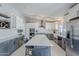 Modern kitchen with gray and white cabinets, an island with seating, and stainless steel appliances at 696 W Mesquite St, Chandler, AZ 85225