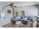 Bright and airy living room features vaulted ceilings, a large sectional sofa, and a decorative ceiling fan at 696 W Mesquite St, Chandler, AZ 85225