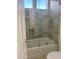 Clean bathroom with a white tub, shower glass, modern tile, and a bright, inviting atmosphere at 7222 E Gainey Ranch Rd # 232, Scottsdale, AZ 85258