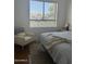 A cozy bedroom offers a tranquil seating area with a cushioned chair and plush rug at 7222 E Gainey Ranch Rd # 232, Scottsdale, AZ 85258