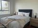 Relax in this well-lit bedroom featuring hardwood floors, a comfortable bed, and stylish nightstands and lamps at 7222 E Gainey Ranch Rd # 232, Scottsdale, AZ 85258
