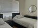 This cozy bedroom showcases two twin beds, modern decor, and comfortable furnishings, perfect for Gathering or guests at 7222 E Gainey Ranch Rd # 232, Scottsdale, AZ 85258
