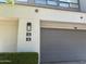 Exterior view of home featuring a two-car garage and address number at 7222 E Gainey Ranch Rd # 232, Scottsdale, AZ 85258
