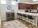Bright kitchen with stainless appliances, wood cabinets, an island with seating, and a view of a decorated table at 7222 E Gainey Ranch Rd # 232, Scottsdale, AZ 85258