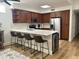 Bright kitchen featuring stainless steel appliances, wood cabinets, island seating, and stylish modern design at 7222 E Gainey Ranch Rd # 232, Scottsdale, AZ 85258