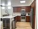 Modern kitchen featuring stainless steel appliances, wood cabinets, and a stylish countertop with a wine cooler at 7222 E Gainey Ranch Rd # 232, Scottsdale, AZ 85258