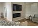 Stylish living room featuring a decorative fireplace, mounted TV, and comfortable seating at 7222 E Gainey Ranch Rd # 232, Scottsdale, AZ 85258