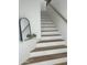 Elegant staircase featuring wood treads, white risers, and a minimalist design at 7222 E Gainey Ranch Rd # 232, Scottsdale, AZ 85258