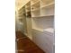 Organized walk-in closet with ample shelving, drawers, and mirrored doors, providing a functional storage solution at 7222 E Gainey Ranch Rd # 232, Scottsdale, AZ 85258