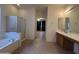 A spacious bathroom with a soaking tub, glass shower, double vanity, and tile floors at 7227 W Paradise Ln, Peoria, AZ 85382
