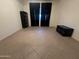 A large bedroom with a window, tile floors, and plenty of room to customize your living space at 7227 W Paradise Ln, Peoria, AZ 85382