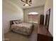 A furnished bedroom with light walls, tile flooring, and window with blinds at 7227 W Paradise Ln, Peoria, AZ 85382
