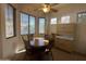 Cozy breakfast nook featuring a round table, wooden chairs, and abundant natural light from multiple windows at 7227 W Paradise Ln, Peoria, AZ 85382