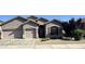 Charming single-story home with desert landscaping, a two-car garage, and a welcoming entryway at 7227 W Paradise Ln, Peoria, AZ 85382