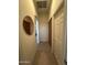 Hallway with tile flooring, wooden cabinets, and an arched doorway enhancing the flow of the home at 7227 W Paradise Ln, Peoria, AZ 85382