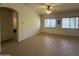 A large living room with tile flooring, natural light, and a ceiling fan for added comfort at 7227 W Paradise Ln, Peoria, AZ 85382