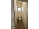 Small powder room features a toilet, tile flooring, and a window for ventilation and light at 7227 W Paradise Ln, Peoria, AZ 85382
